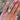 A close-up of a hand wearing a custom-made 14k gold dutch marquise lab grown diamond solitaire engagement ring